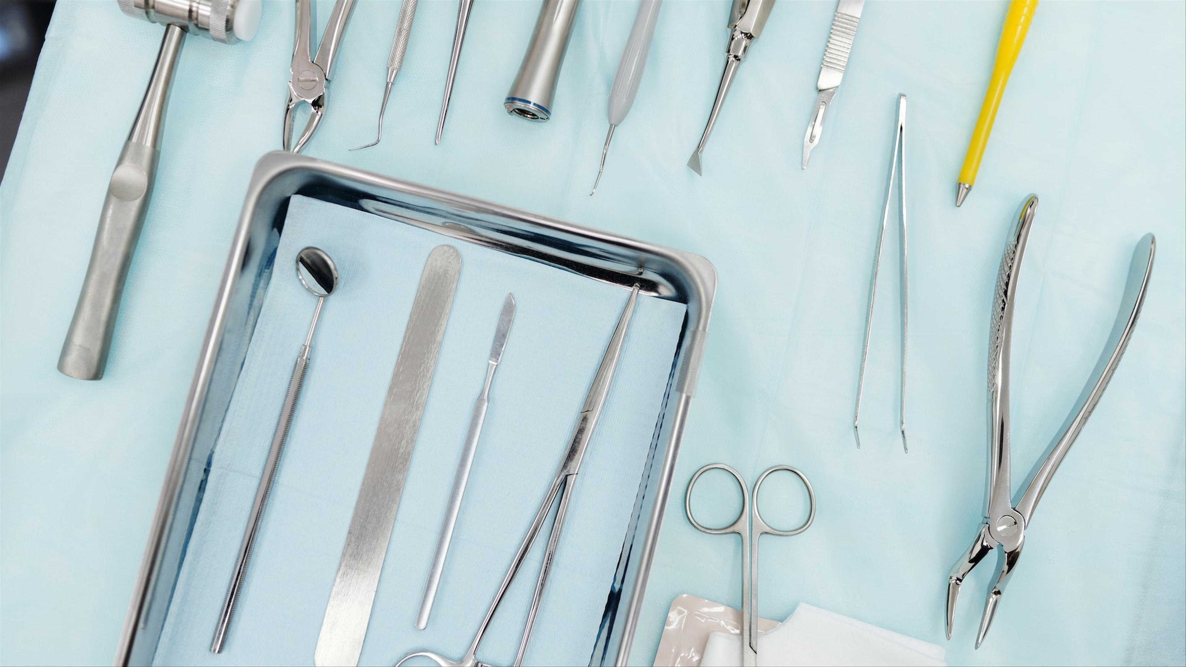 Dental surgeon preparing for a procedure at Klinik Pergigian T3